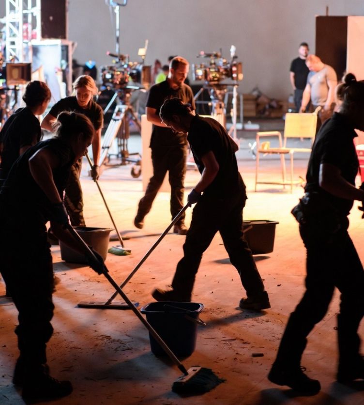 professional cleaning team tidying a busy film set